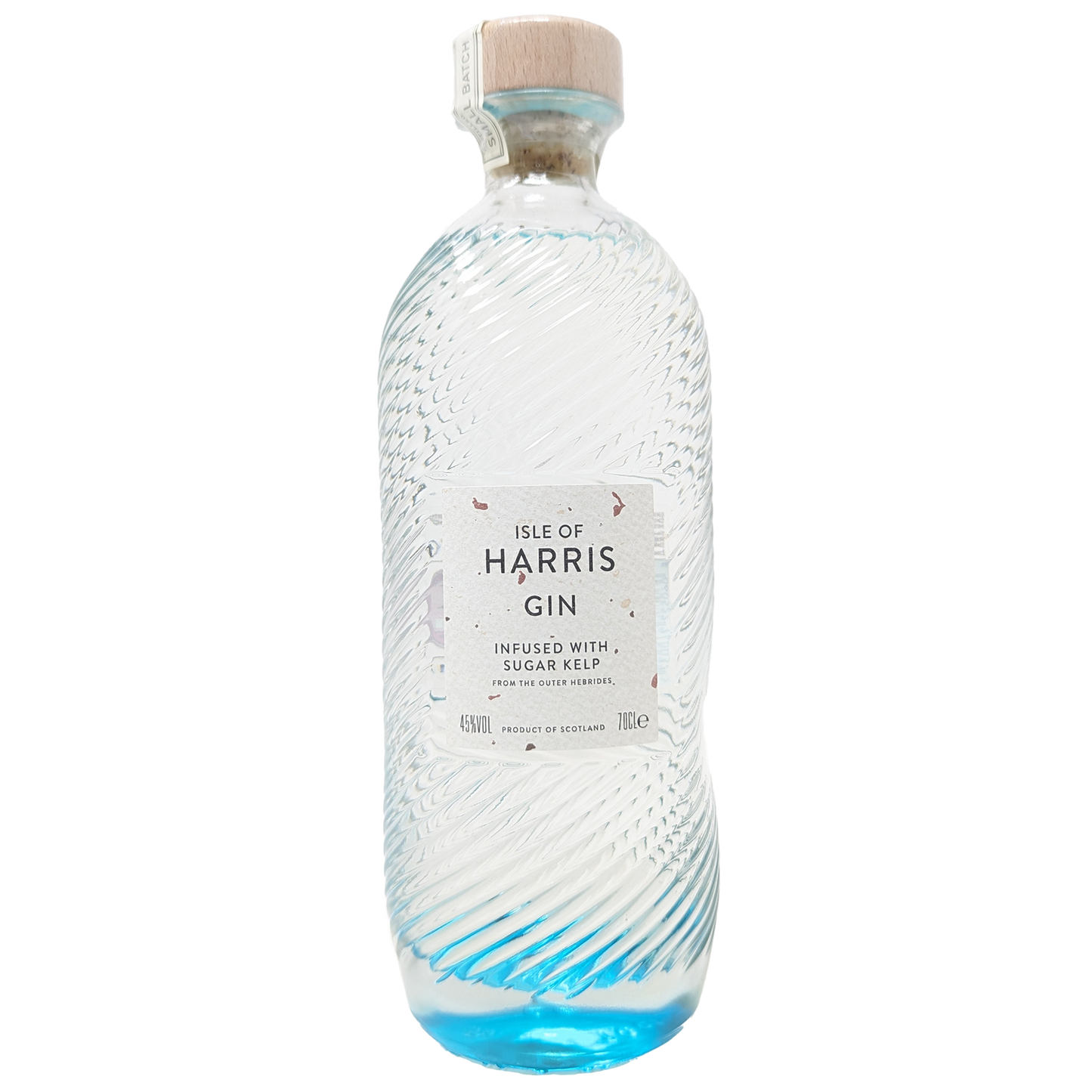 a bottle of the isle of harris gin from the isle of harris distillery with its iconic blue bottom fading into a clear bottle with copper flakes in the wite label