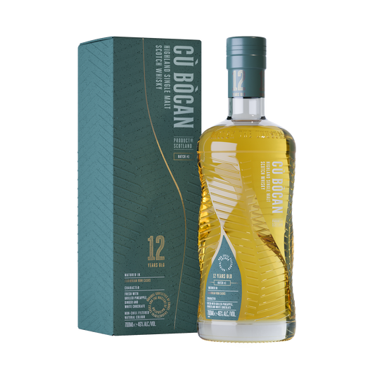 A bottle of cu bocan single malt 12 year old rum cask finish whisky with its teal and gold label in a lined and twisted bottle with gold whisky inside beside its teal and gold box