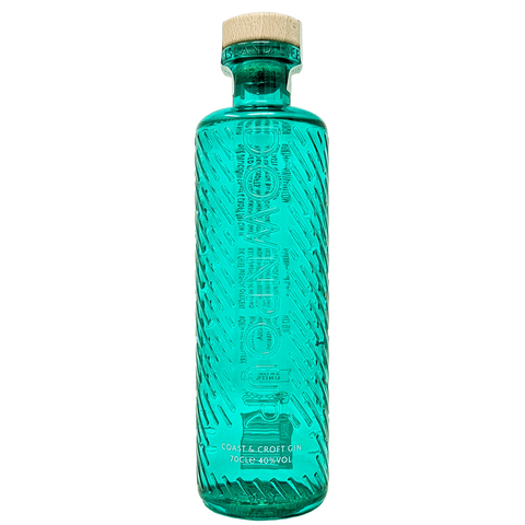 Bottle of downpours coast & croft original gin from the north uist distillery in its teal green bottle 