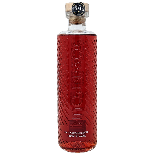 Bottle of downpours oak aged negroni pre mixed gin cocktail from the north uist distillery in its clear bottle and red liquid