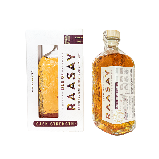 bottle of the Isle of Raasay cask strength single malt whisky special release beside a white boxed bottle of the same whisky 