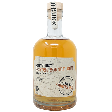 Bottle of South Uist Scotch Bonnet Rum from the South Uist Distillery. Label shows the South Uist Distillery branding with Scotch Bonnet Rum written and a light map of the South Uist islands in the background. 