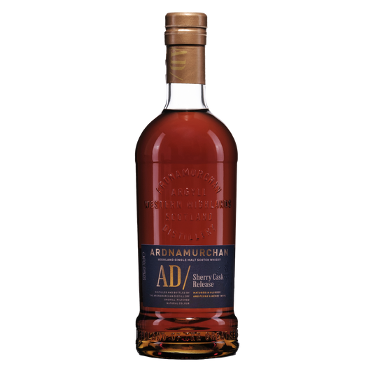 A bottle of Ardnamurchan Sherry release single malt dark red whisky in a bottle embossed with the adrnamurchan logo and a navy blue label with gold writing 