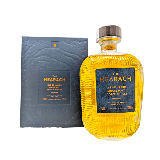 A bottle of the original hearach single malt whisky from the isle of harris distillery with a grey hearach box in the back ground. 