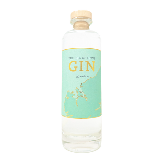 A bottle of Isle of lewis gin with its teal and gold label 